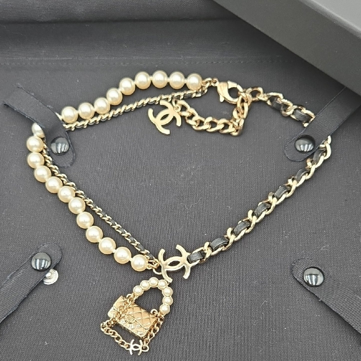 #112 Chanel Coco Mark, Matelasse Bag Motif, Faux Pearl, and Leather - B21SAB6125