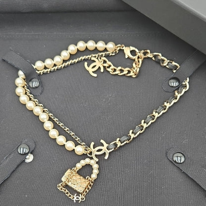 #112 Chanel Coco Mark, Matelasse Bag Motif, Faux Pearl, and Leather - B21SAB6125