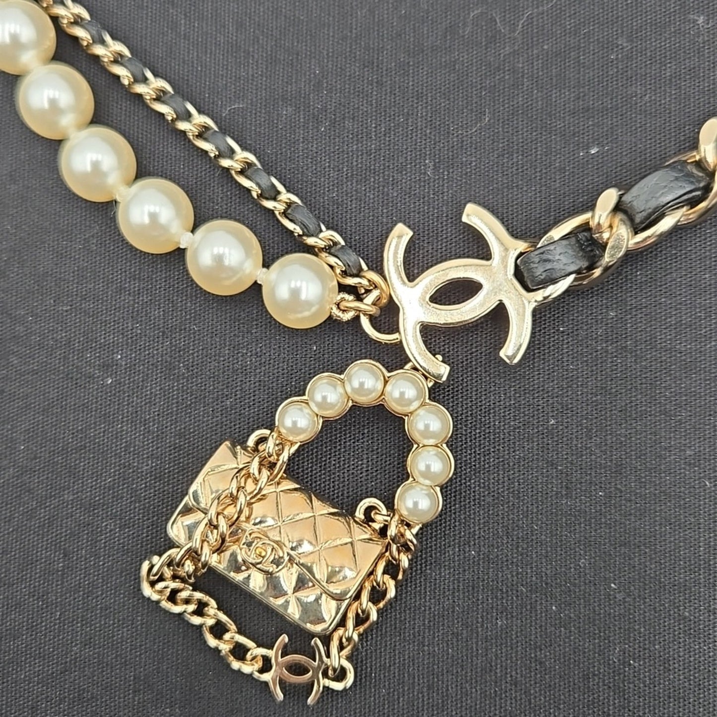 #112 Chanel Coco Mark, Matelasse Bag Motif, Faux Pearl, and Leather - B21SAB6125
