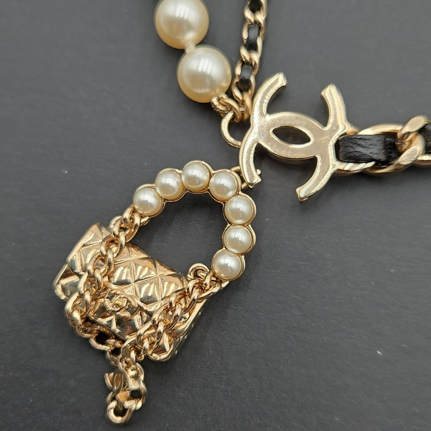 #112 Chanel Coco Mark, Matelasse Bag Motif, Faux Pearl, and Leather - B21SAB6125