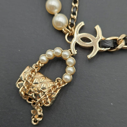 #112 Chanel Coco Mark, Matelasse Bag Motif, Faux Pearl, and Leather - B21SAB6125
