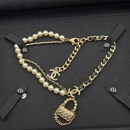 #112 Chanel Coco Mark, Matelasse Bag Motif, Faux Pearl, and Leather - B21SAB6125