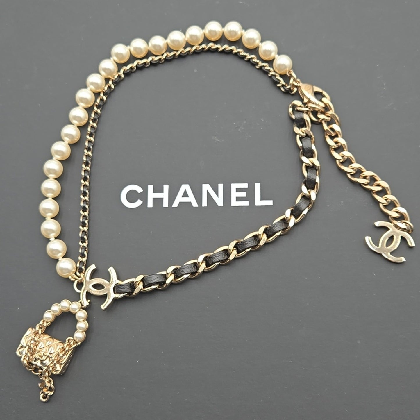 #112 Chanel Coco Mark, Matelasse Bag Motif, Faux Pearl, and Leather - B21SAB6125