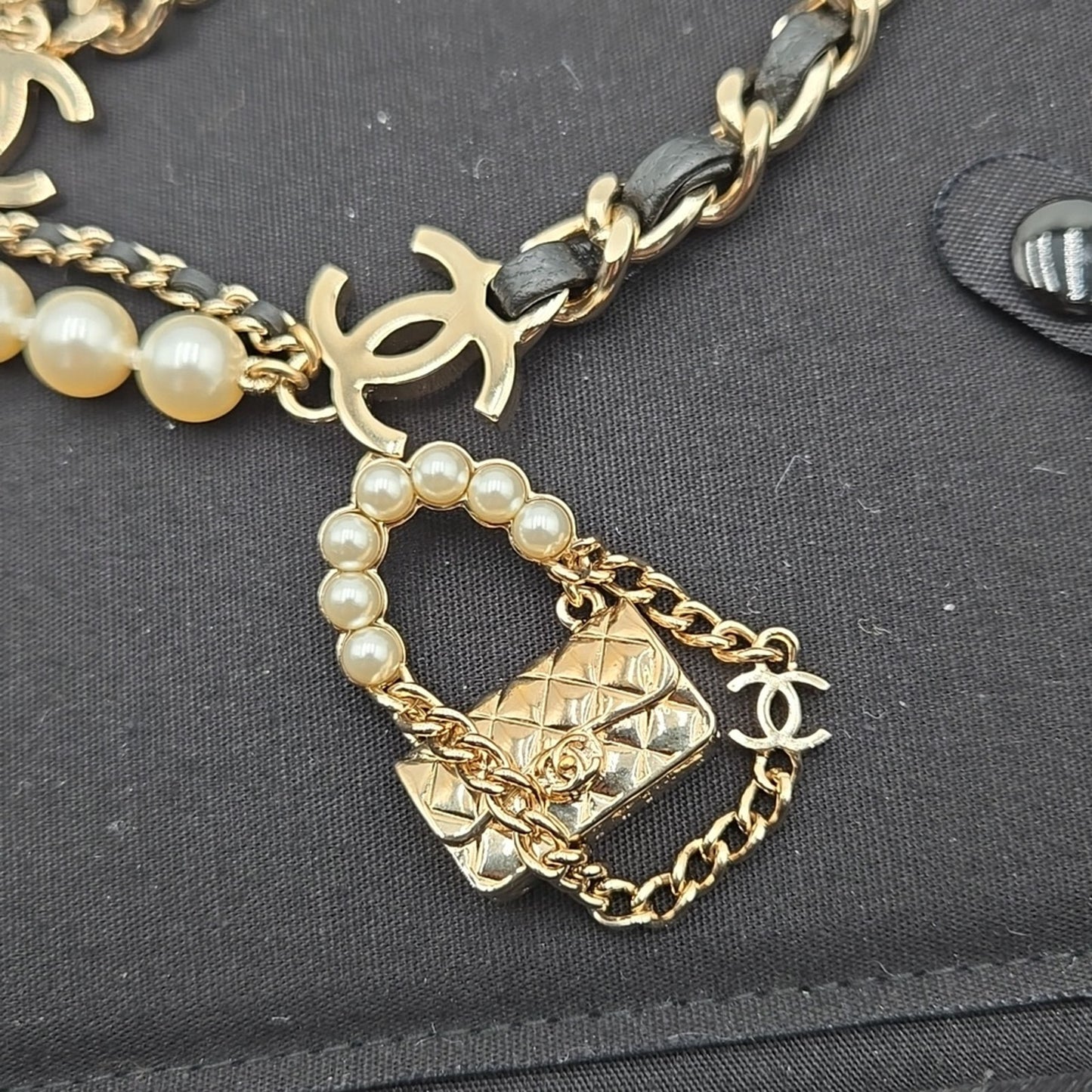 #112 Chanel Coco Mark, Matelasse Bag Motif, Faux Pearl, and Leather - B21SAB6125